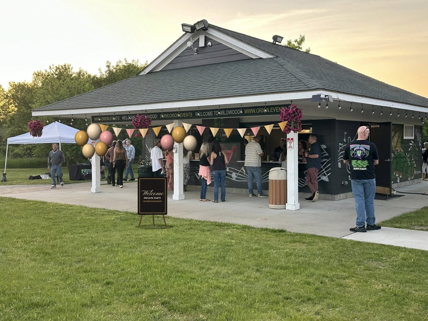 The AMP Pavilion Bar at Wildwood decorated for a private party with balloons, bunting and a welcome sign